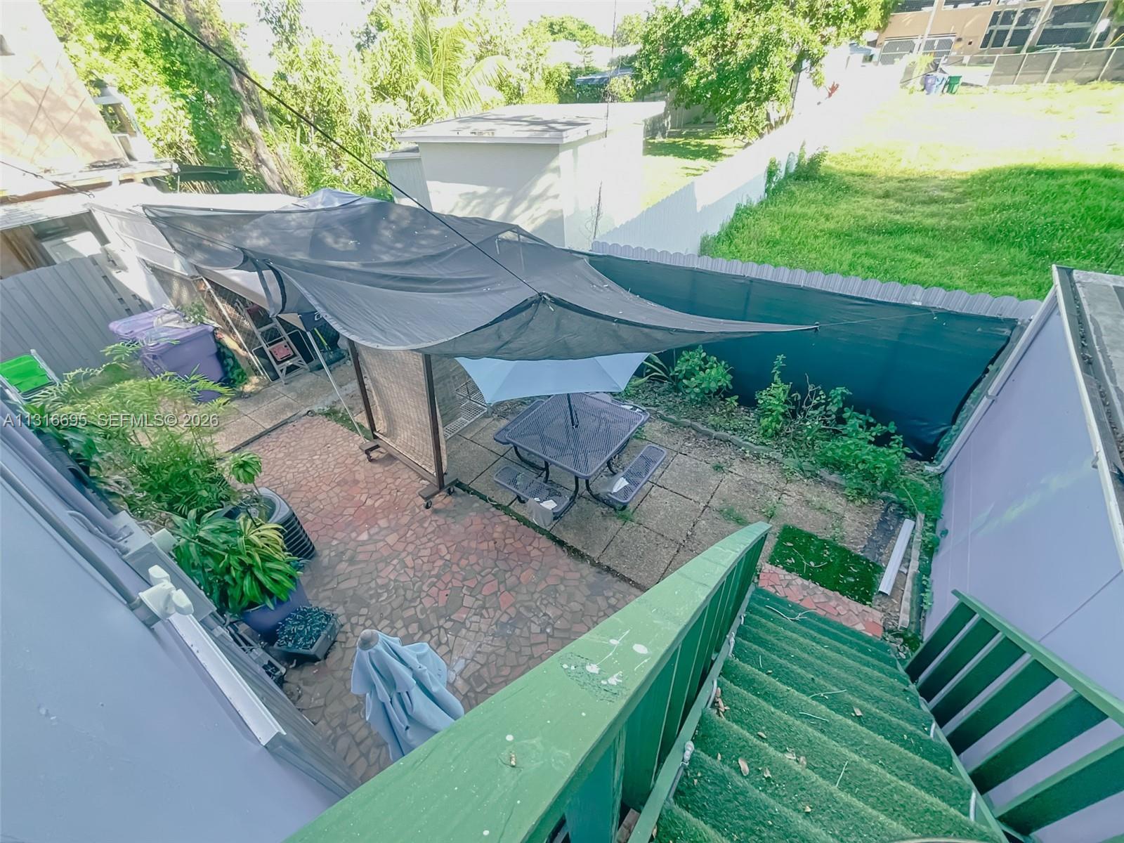 3682 Southwest 26th Street, Unit 2 Miami, FL 33133 - Photo 23 of 23 a view of an outdoor sitting area with brick walls
