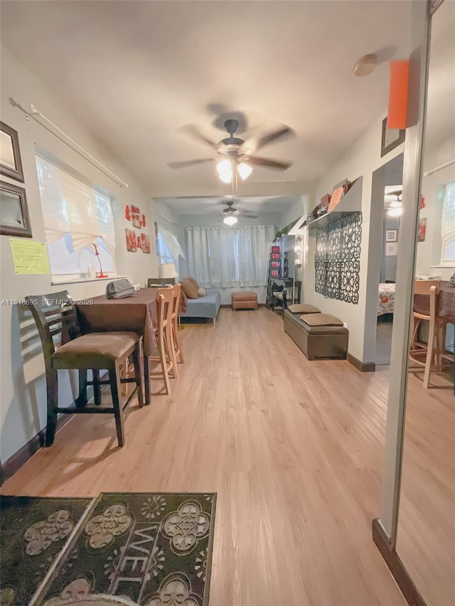 3682 Southwest 26th Street, Unit 2 Miami, FL 33133 - Photo 6 of 23 a living room with furniture and a chandelier