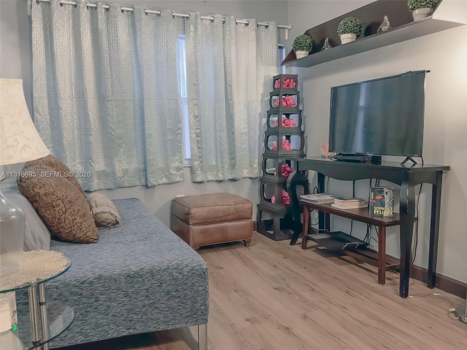 3682 Southwest 26th Street, Unit 2 Miami, FL 33133 - Photo 7 of 23 a living room with furniture and a wooden floor