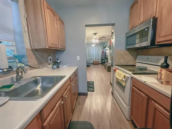 a kitchen with a sink stove and cabinets