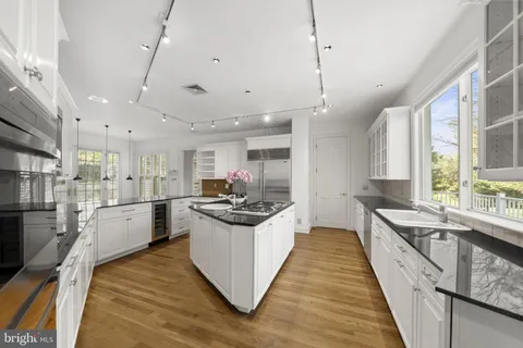 a view of a hallway with white cabinets