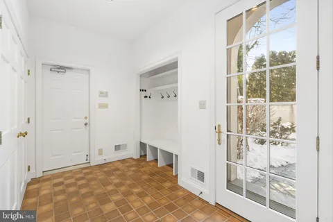 a view of an empty room with chandelier