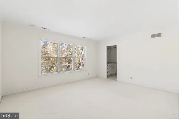 a view of an empty room with chandelier