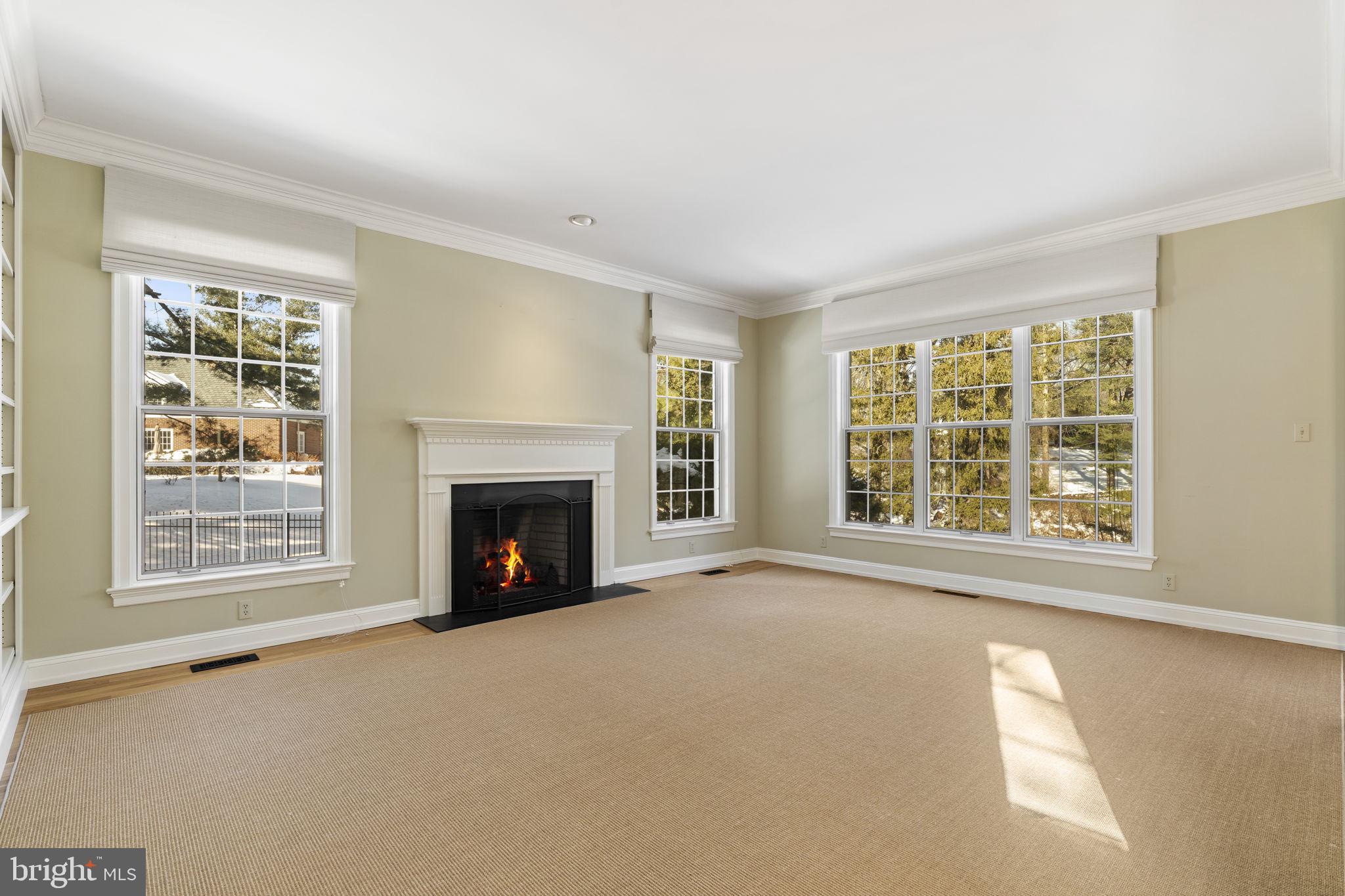841 Mt Moro Road Villanova, PA 19085 - Photo 9 of 57 an empty room with a fireplace and window