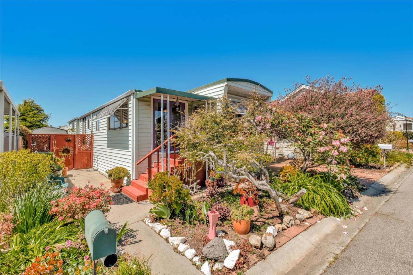 4160 Jade Street, Unit 74 Capitola, CA 95010 - Photo 1 of 25 a front view of a house with a yard