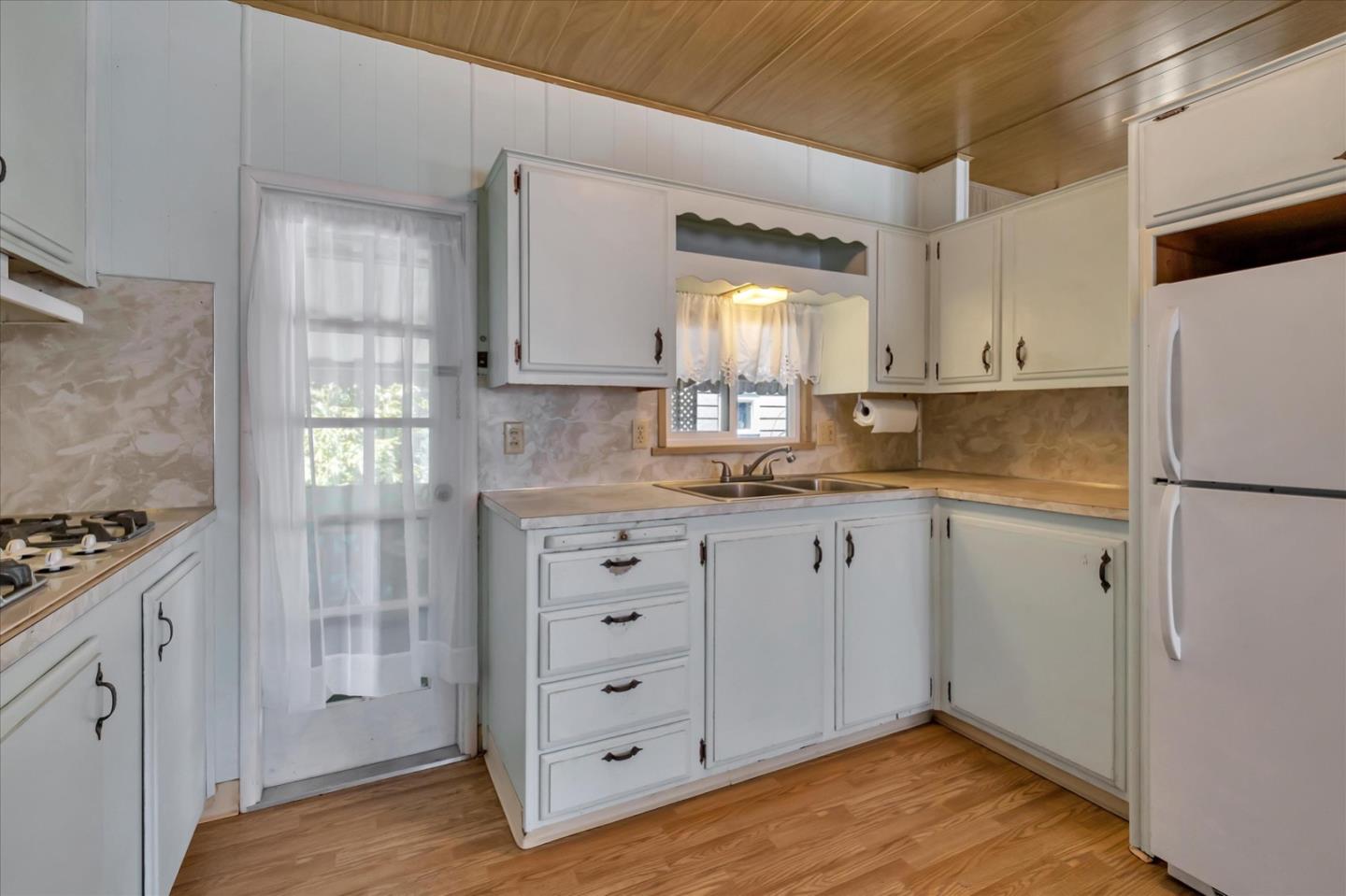 4160 Jade Street, Unit 74 Capitola, CA 95010 - Photo 10 of 25 a kitchen with cabinets appliances and a window