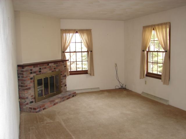 1467 West Cedarville Road Freeport, IL 61032 - Photo 7 of 9 an empty room with windows and fireplace