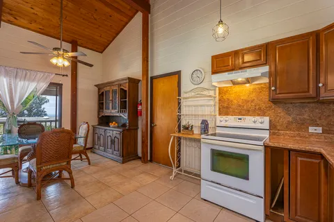 a kitchen with furniture and a stove
