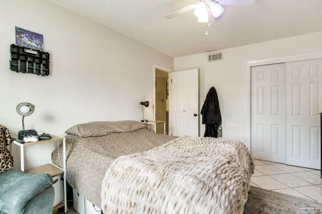 a bed sitting in a bedroom and chandelier