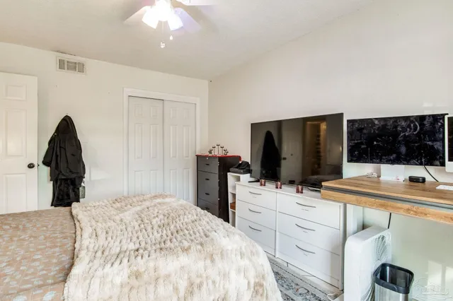 a bedroom with a bed and a flat screen tv