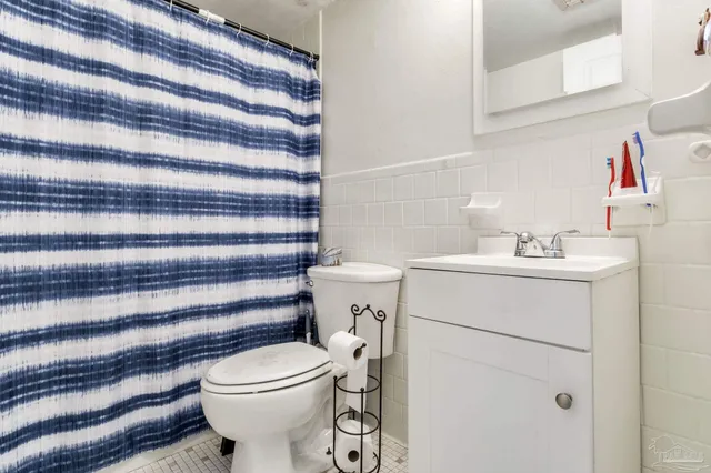 a bathroom with a sink toilet and a mirror