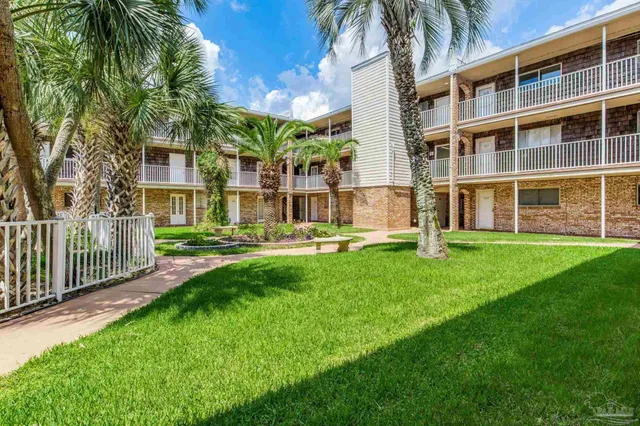 a view of a house with a yard and plants