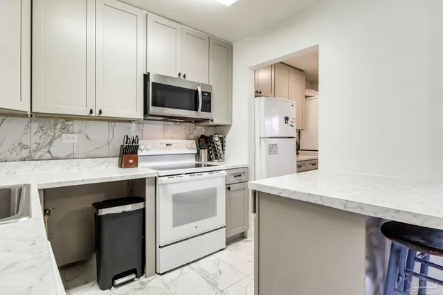 a kitchen with a sink a stove and refrigerator