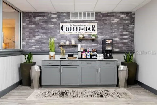 a kitchen with stainless steel appliances kitchen island granite countertop a refrigerator