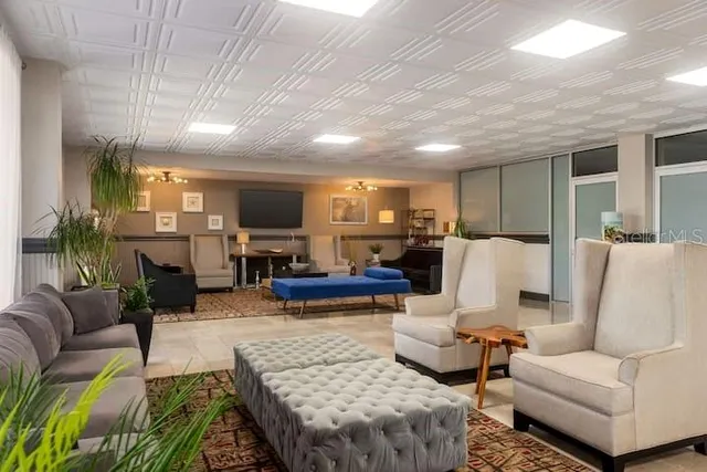 a living room with furniture wooden floor and a view of kitchen
