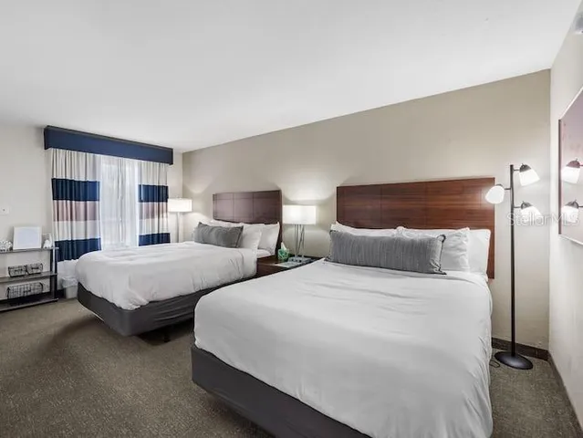 a bedroom with two beds and painted walls