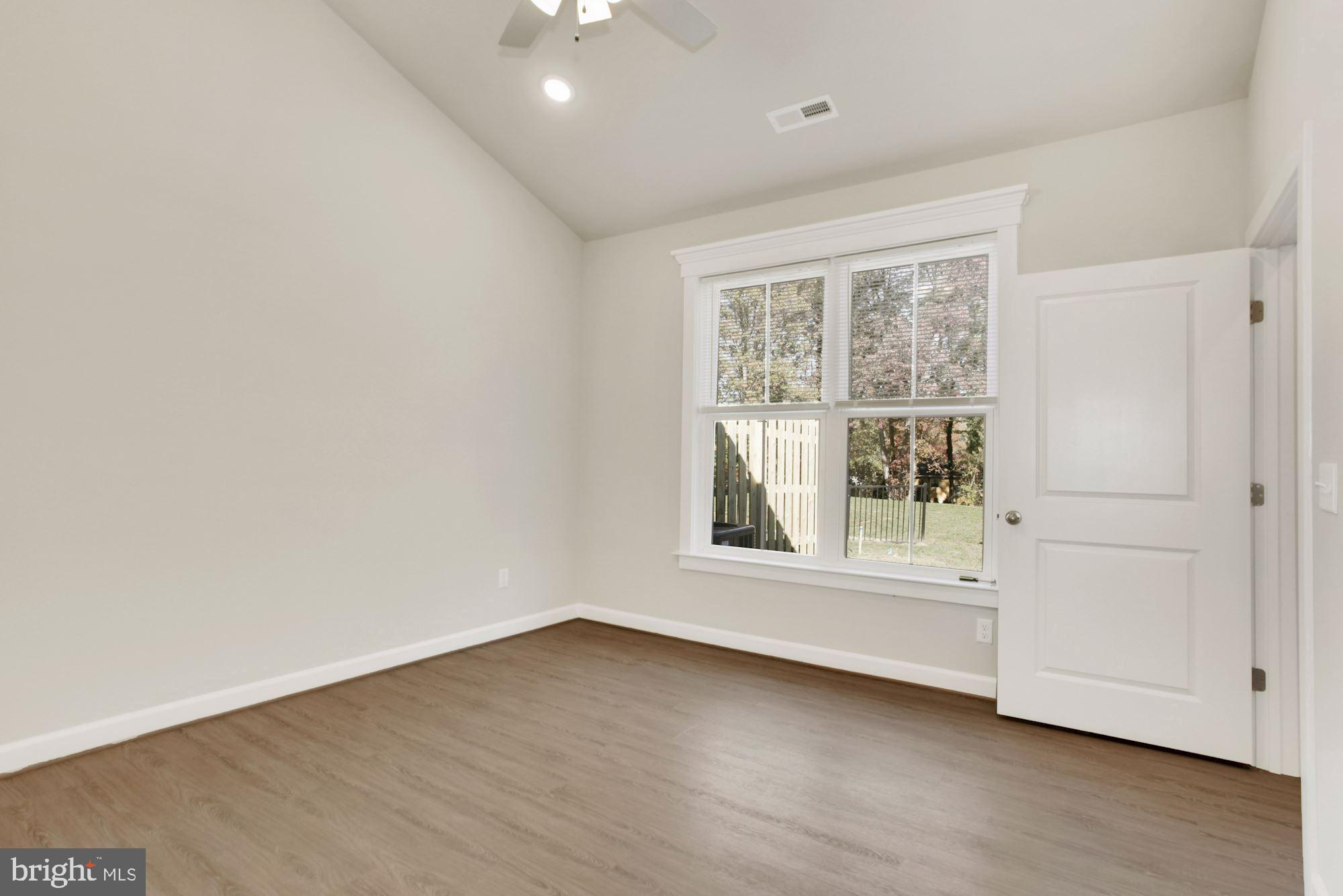 5606 Finley Rose Court Fredericksburg, VA 22407 - Photo 11 of 23 an empty room with wooden floor and windows