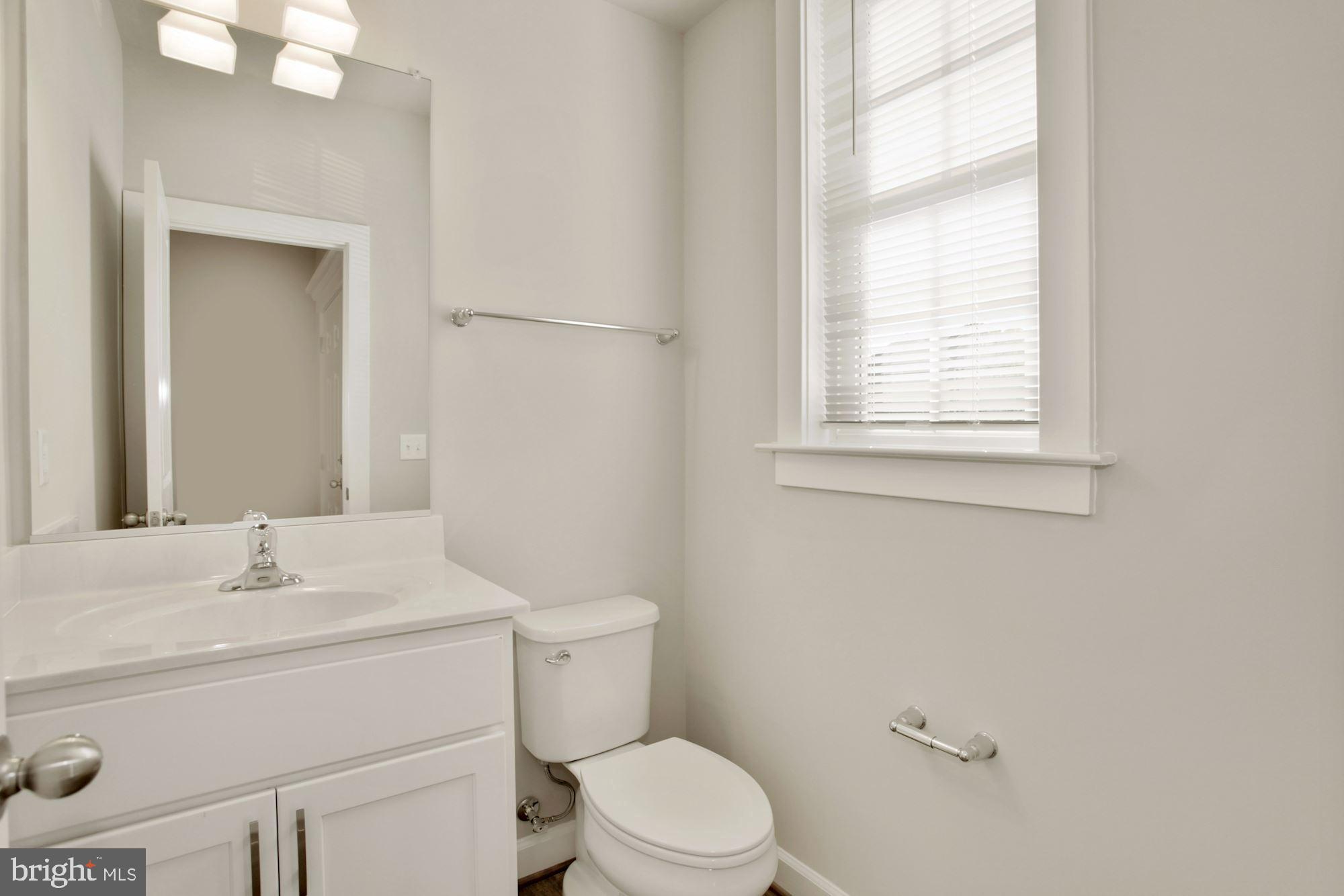 5606 Finley Rose Court Fredericksburg, VA 22407 - Photo 20 of 23 a bathroom with a sink toilet and mirror