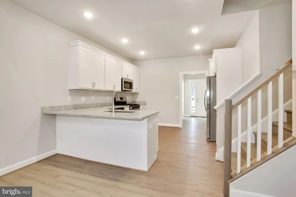 a view of kitchen with sink microwave and stove