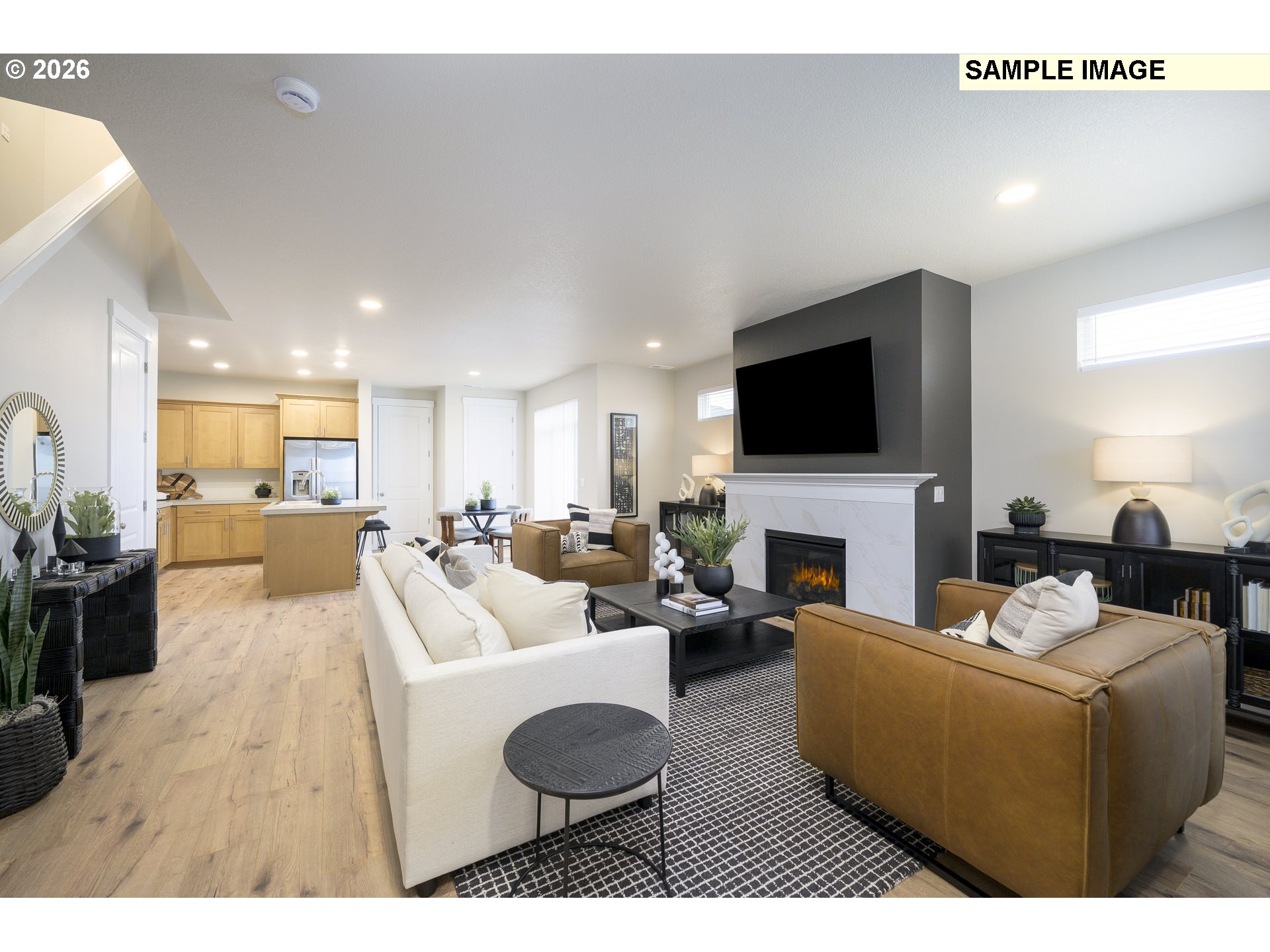 3159 South Kodiak Street, Unit L797 Cornelius, OR 97113 - Photo 3 of 18 a living room with furniture a fireplace and a flat screen tv