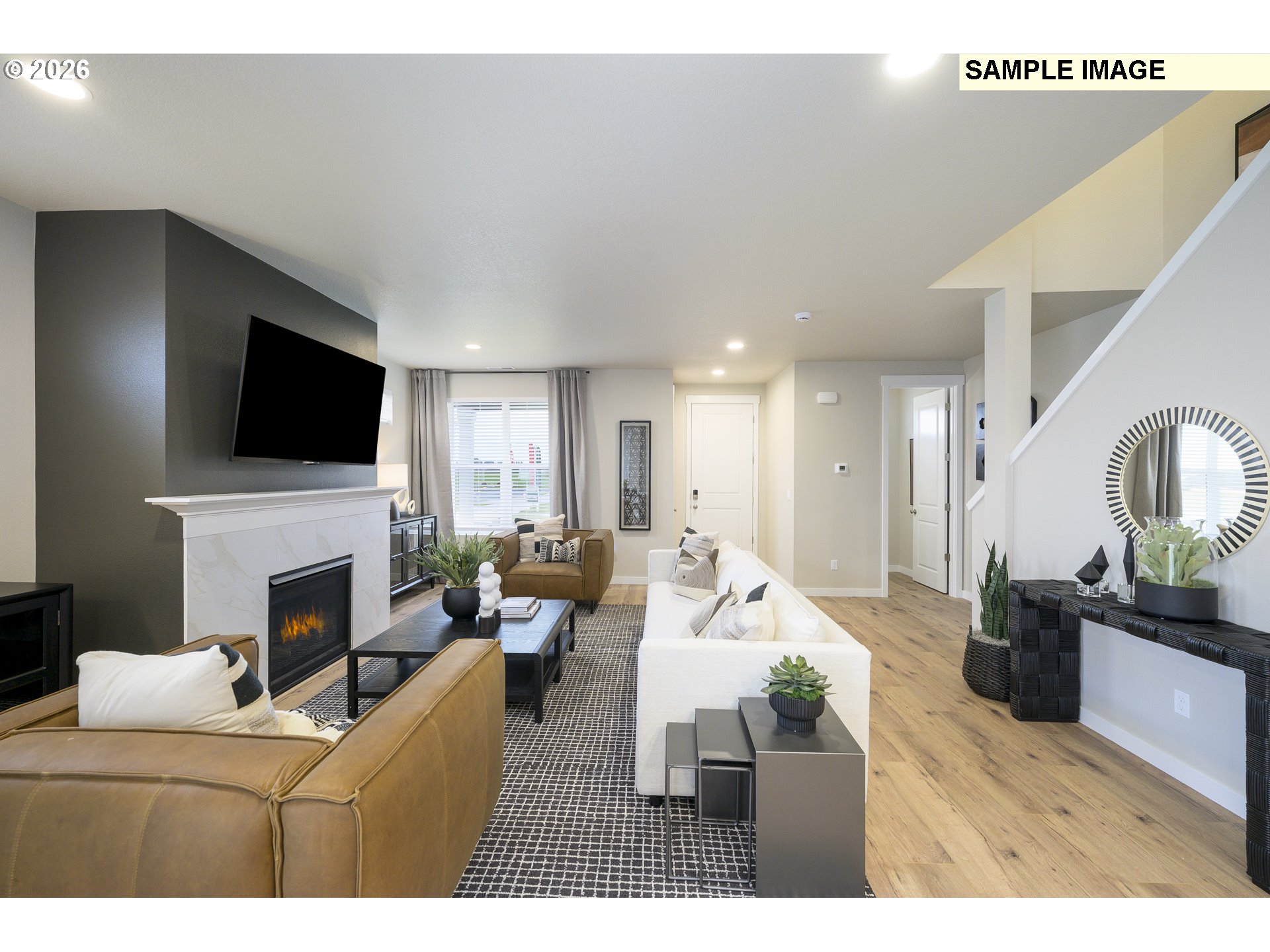 3159 South Kodiak Street, Unit L797 Cornelius, OR 97113 - Photo 5 of 18 a living room with furniture a fireplace and a flat screen tv