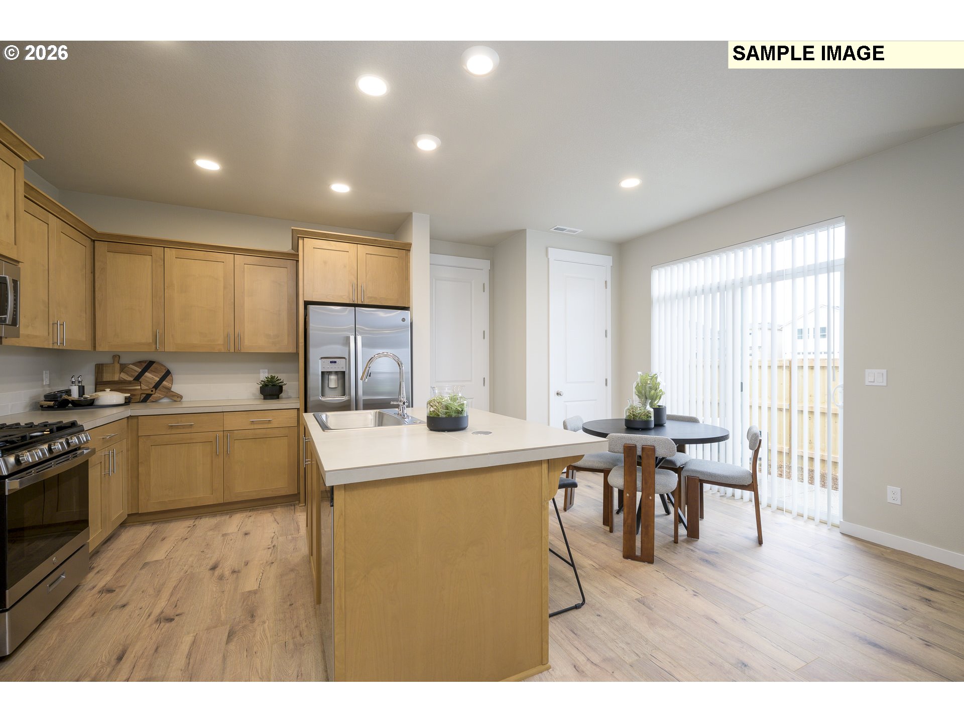 3159 South Kodiak Street, Unit L797 Cornelius, OR 97113 - Photo 6 of 18 a living room with stainless steel appliances kitchen island granite countertop furniture a dining table and chairs with wooden floor