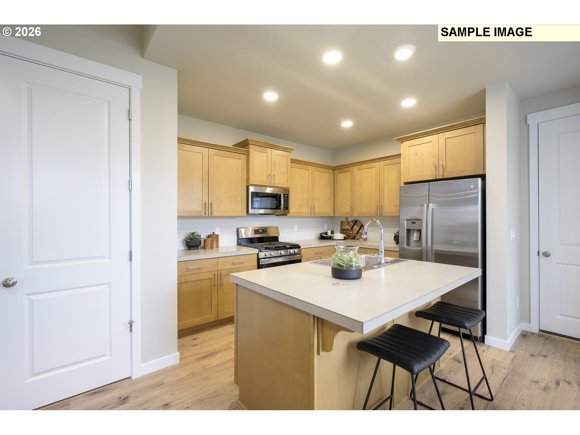 3159 South Kodiak Street, Unit L797 Cornelius, OR 97113 - Photo 7 of 18 a kitchen with a sink a refrigerator and cabinets