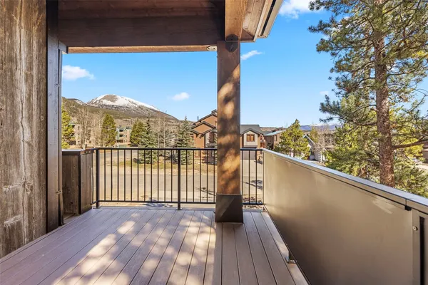 a view of balcony with furniture and mountain view