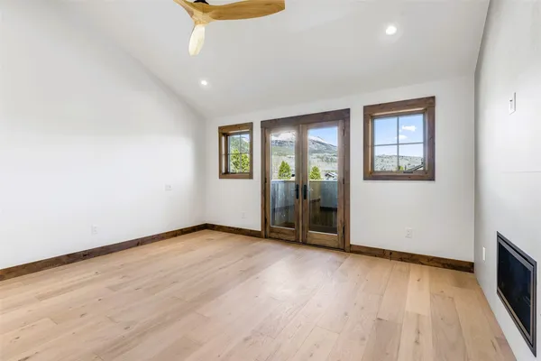 a view of a hallway with wooden floor and staircase