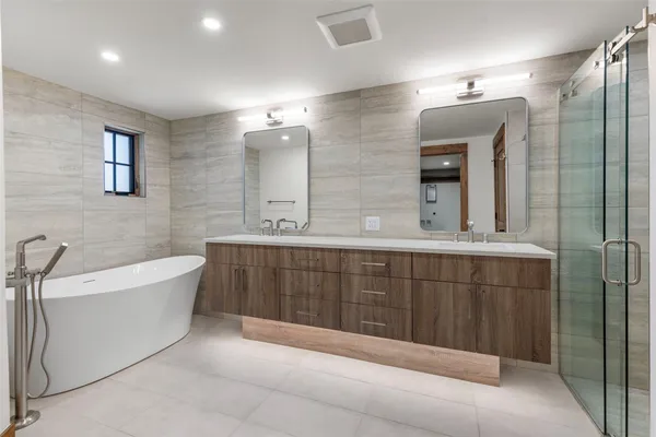 a bathroom with a sink toilet a mirror and shower