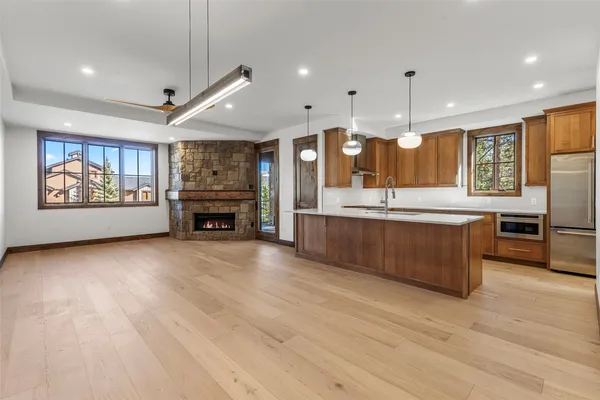 a view of an empty room with a fireplace and a window