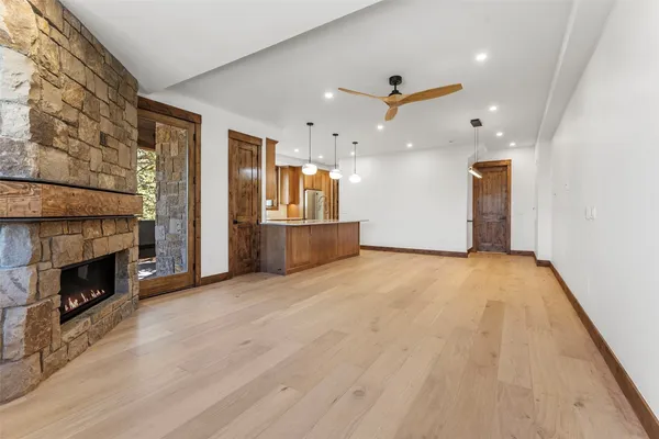 a view of an empty room and wooden floor