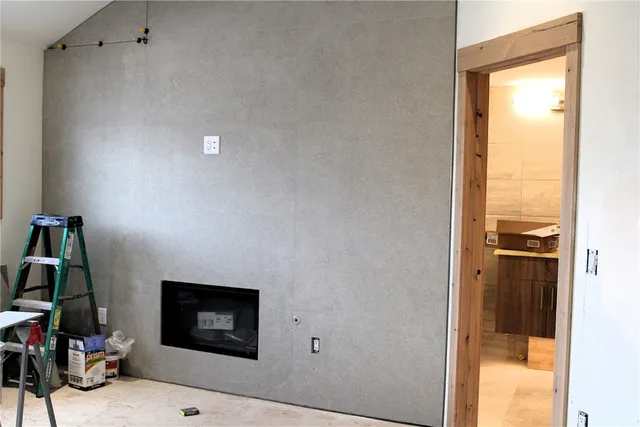 a view of a hallway with workspace and a window