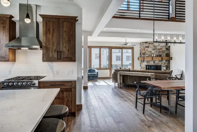 a kitchen with stainless steel appliances a stove a sink dishwasher and cabinets with wooden floor