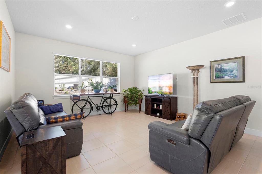 2024 Canopy Terrace Boulevard DeLand, FL 32724 - Photo 12 of 25 a living room with furniture and a flat screen tv