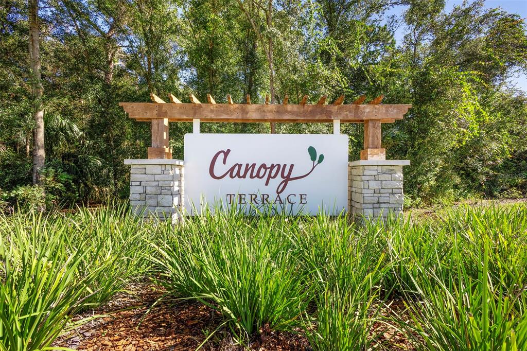 2024 Canopy Terrace Boulevard DeLand, FL 32724 - Photo 4 of 25 a sign that is sitting in front of flowers