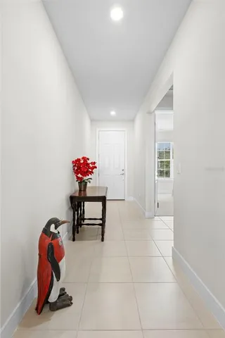 a dining room with furniture and a potted plant