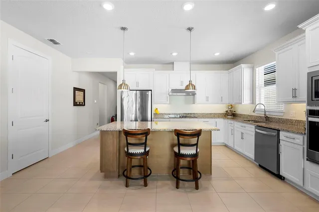 a large kitchen with a table and chairs in it
