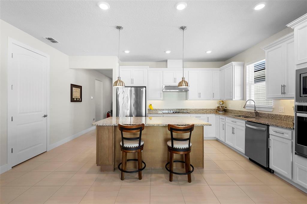 2024 Canopy Terrace Boulevard DeLand, FL 32724 - Photo 9 of 25 a large kitchen with a table and chairs in it
