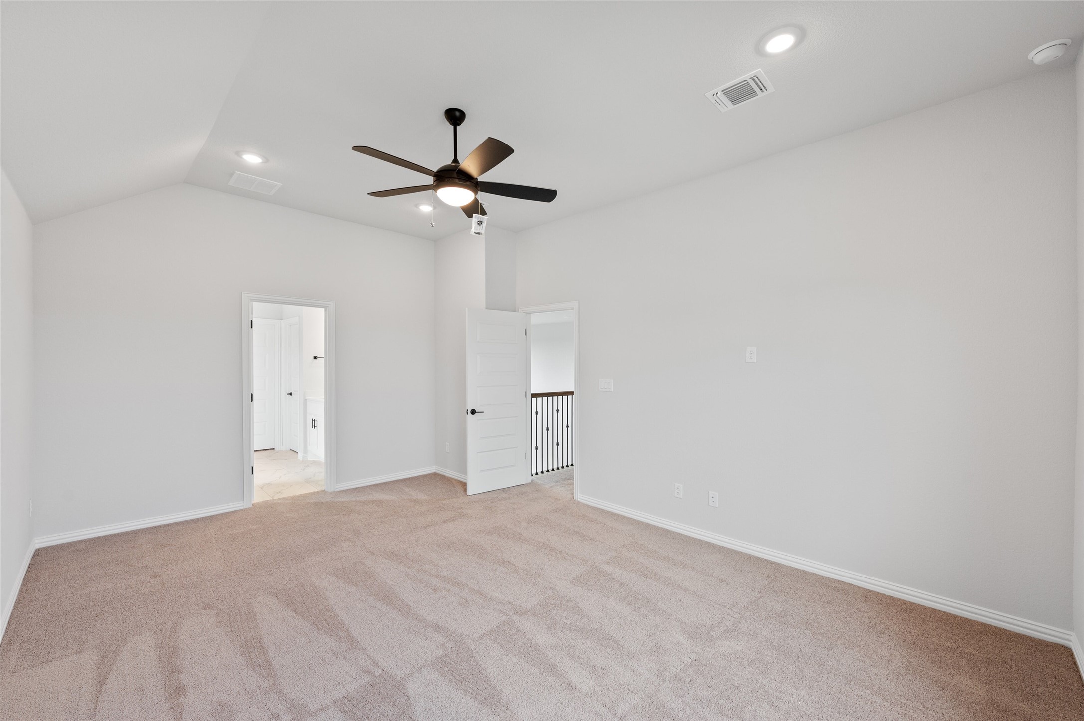 303 Fawn Riv Run Kyle, TX 78640 - Photo 16 of 32 Spacious room featuring vaulted ceilings, recessed lighting, a ceiling fan, and plush carpet flooring