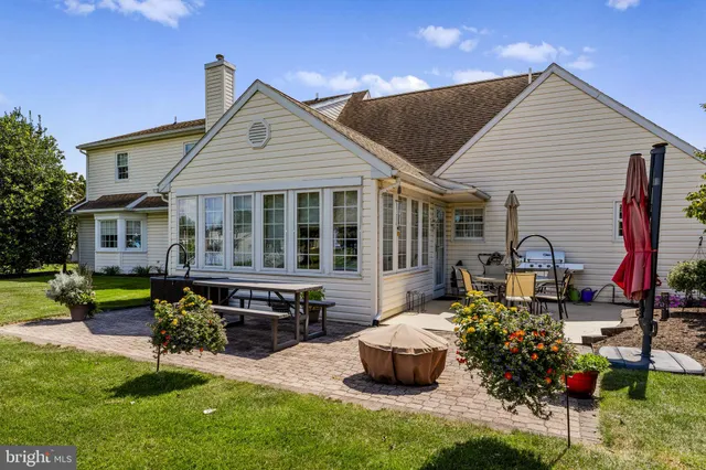 a view of a house with backyard and sitting area