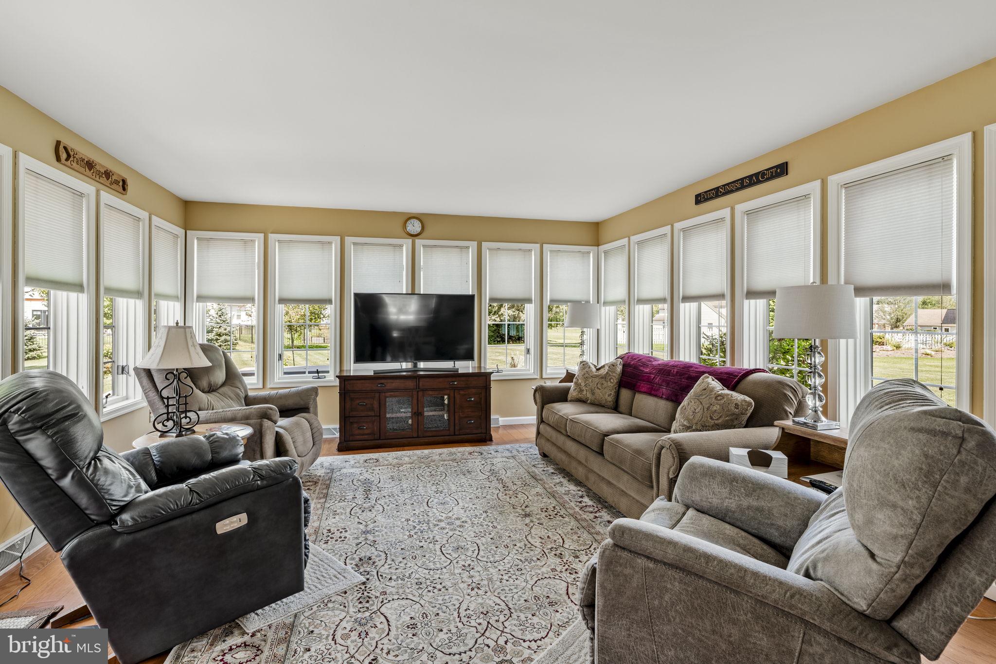 4 Eagle Circle Denver, PA 17517 - Photo 33 of 61 a living room with furniture a flat screen tv and a large window