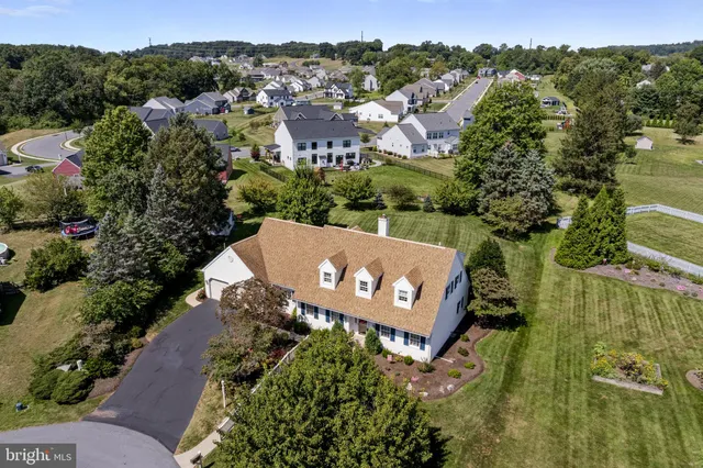 an aerial view of a house with yard swimming pool and outdoor seating