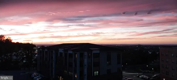 a balcony with wooden floor and outdoor seating