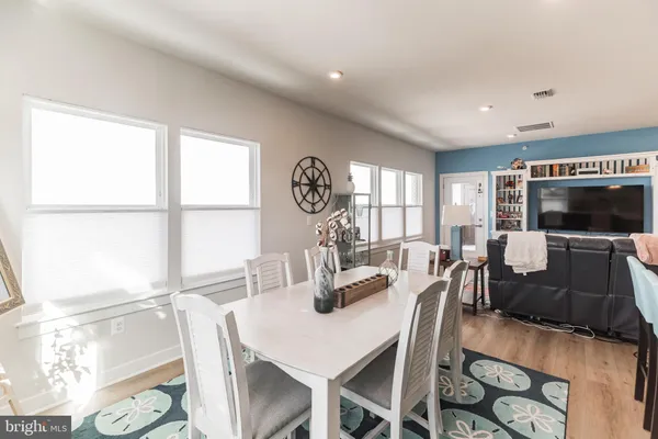 a kitchen with stainless steel appliances kitchen island granite countertop a refrigerator and a sink