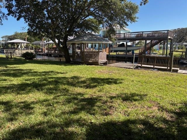 237 Basque Road St. Augustine, FL 32080 - Photo 2 of 13 View of grassy yard with a deck, a gazebo, and stairway