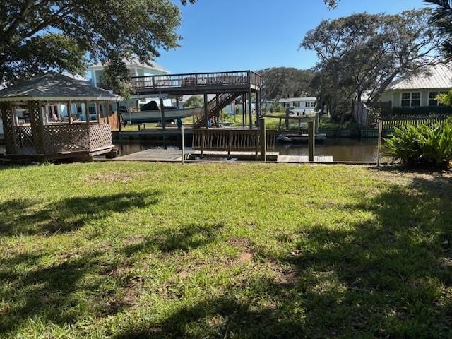 237 Basque Road St. Augustine, FL 32080 - Photo 6 of 13 View of green lawn featuring a dock, a deck with water view, and boat lift