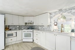 149 Broad Street Barre, MA 01005 - Photo 4 of 34 a kitchen with granite countertop white cabinets and white appliances