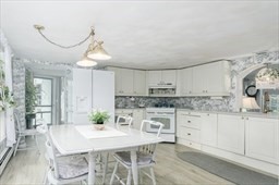 149 Broad Street Barre, MA 01005 - Photo 7 of 34 a kitchen with kitchen island granite countertop a stove a sink and white cabinets with wooden floor