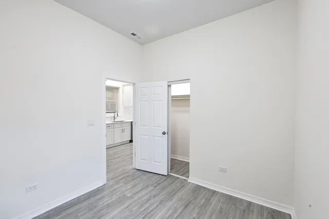 a view of empty room with wooden floor